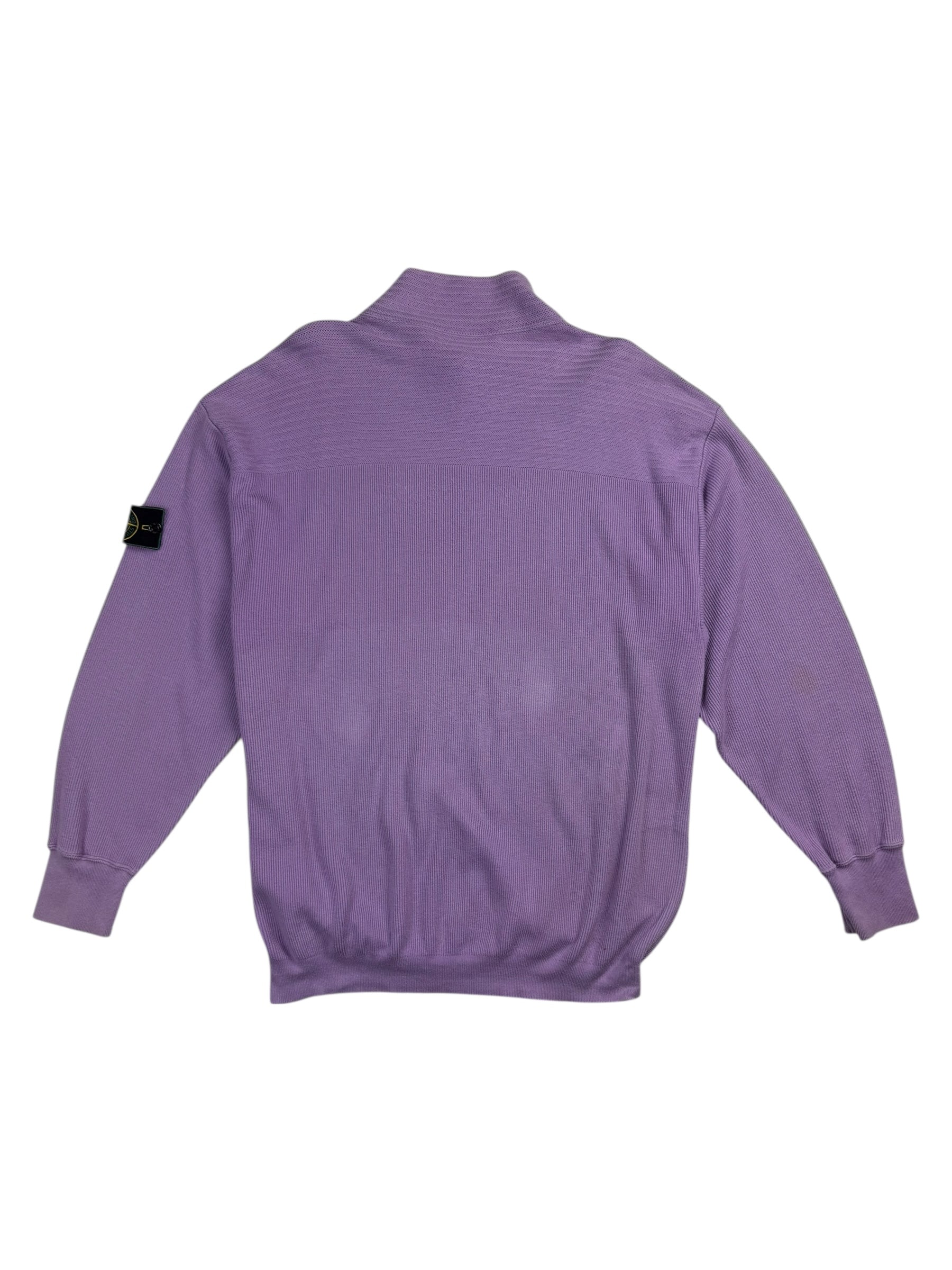 Purple sweater with a black patch on the sleeve against a white background